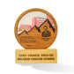 A custom wooden school staff council award plaque on a light wood base. The round wooden top features an engraved portrait of Principal Said Babu, a mountain silhouette, a school building illustration, and a quote.
