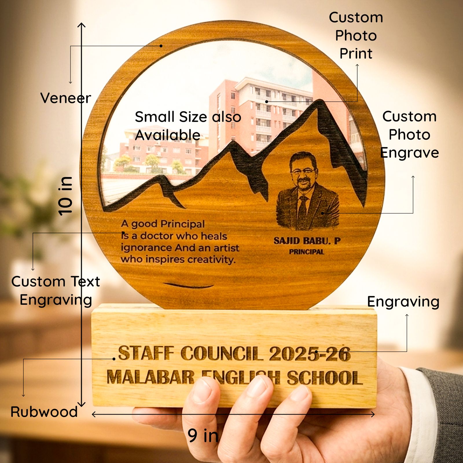 A hand holds a custom engraved wooden school staff council plaque and base. The round top features a veneer finish with an engraved mountain graphic, a portrait, and text, with callouts indicating 10 in height and 9 in width.